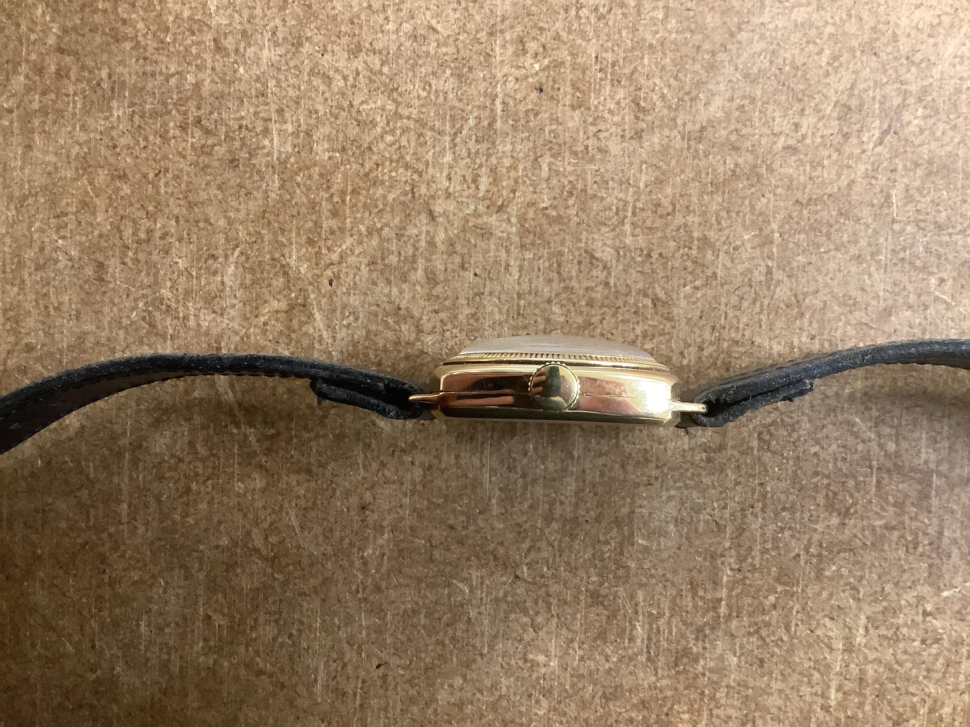A gentleman's yellow metal J.W. Benson manual wrist watch, with Arabic dial and subsidiary seconds, on a black leather strap.